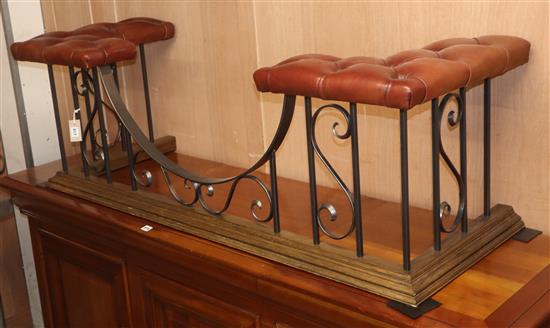 A wrought iron and brown leather club fender W.150cm